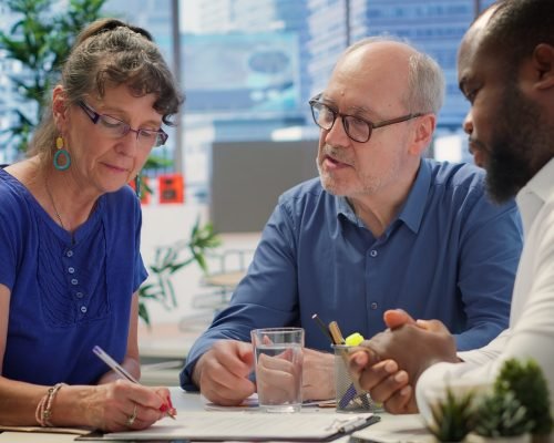 Middle aged couple explores life insurance contract terms with financial adviser